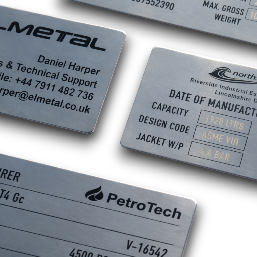 Close-up of laser engraved text on 304 stainless steel nameplate showing deep permanent marking